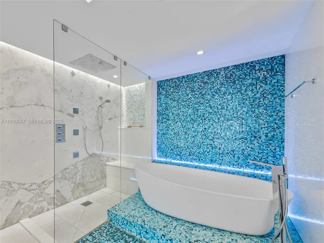 a bathroom with a bathtub and shower