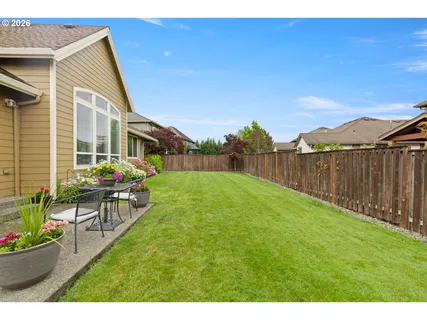 a view of a backyard with wooden fence