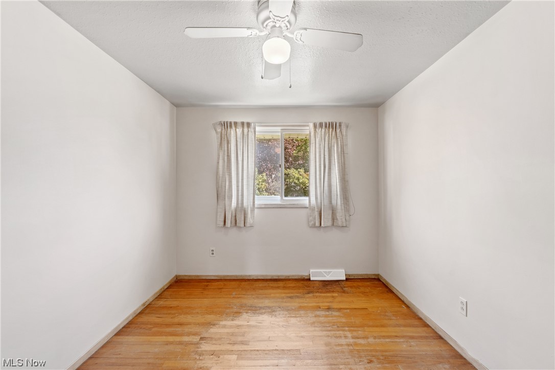 1722 Chelmsford Road Cleveland, OH 44124 - Photo 20 of 34 Hardwood floored empty room featuring ceiling fan