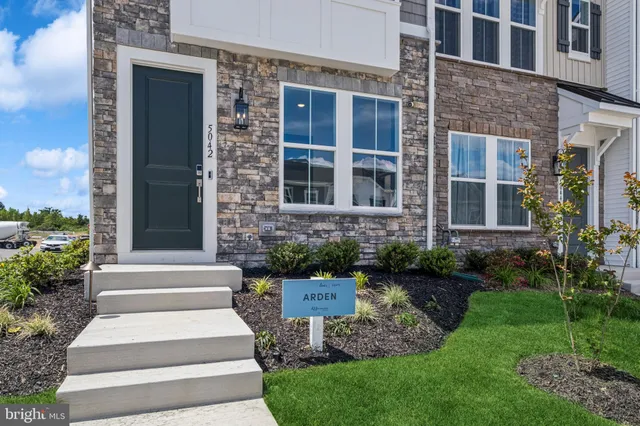 a view of a house with a yard and plants