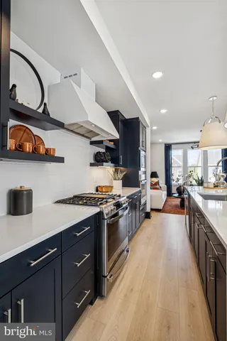 a kitchen with stove and cabinets