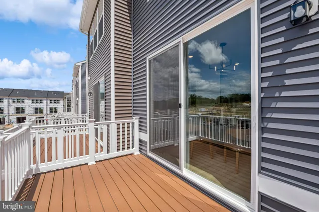 a view of a balcony with wooden floor