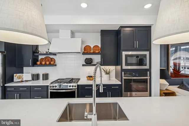 a kitchen with stainless steel appliances granite countertop a stove and a sink