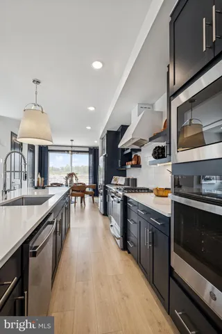a kitchen with stainless steel appliances granite countertop a stove and a sink