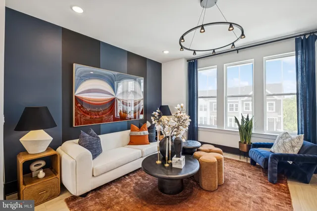 a living room with furniture potted plant and a large window