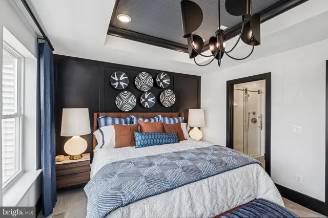 a bedroom with a bed and dresser with mirror