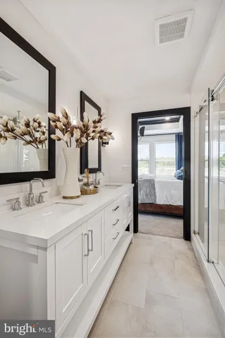 a spacious bathroom with a double vanity sink and a mirror