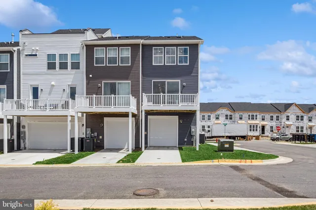 a front view of a residential apartment building with a yard