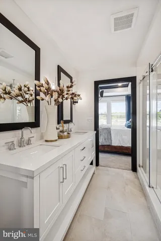 a spacious bathroom with a double vanity sink and a mirror