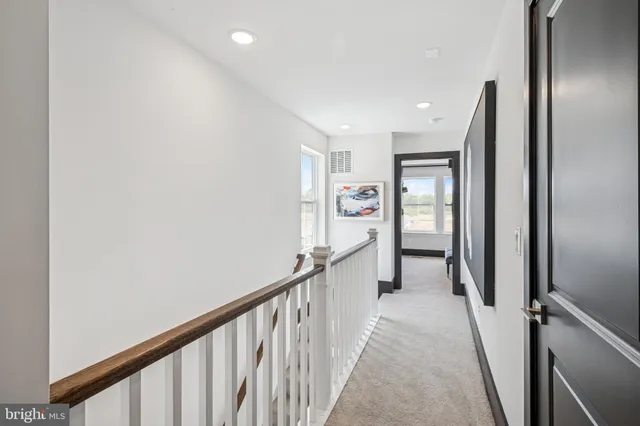 a view of a hallway with closet and stairs