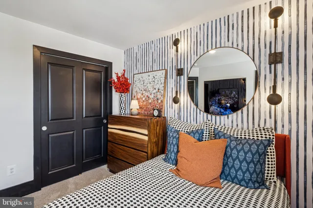 a room with a couch a rug and a fireplace