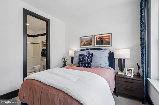 a bedroom with a bed and a painting on the wall