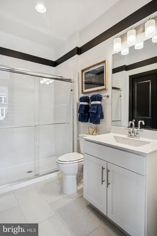 a bathroom with a toilet a sink and a mirror