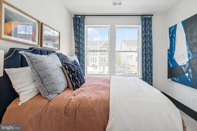 a bed sitting in a bedroom next to a window