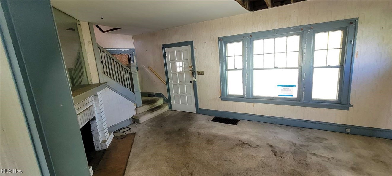 927 Yellowstone Road Cleveland Heights, OH 44121 - Photo 6 of 13 Foyer entrance featuring a fireplace and carpet flooring