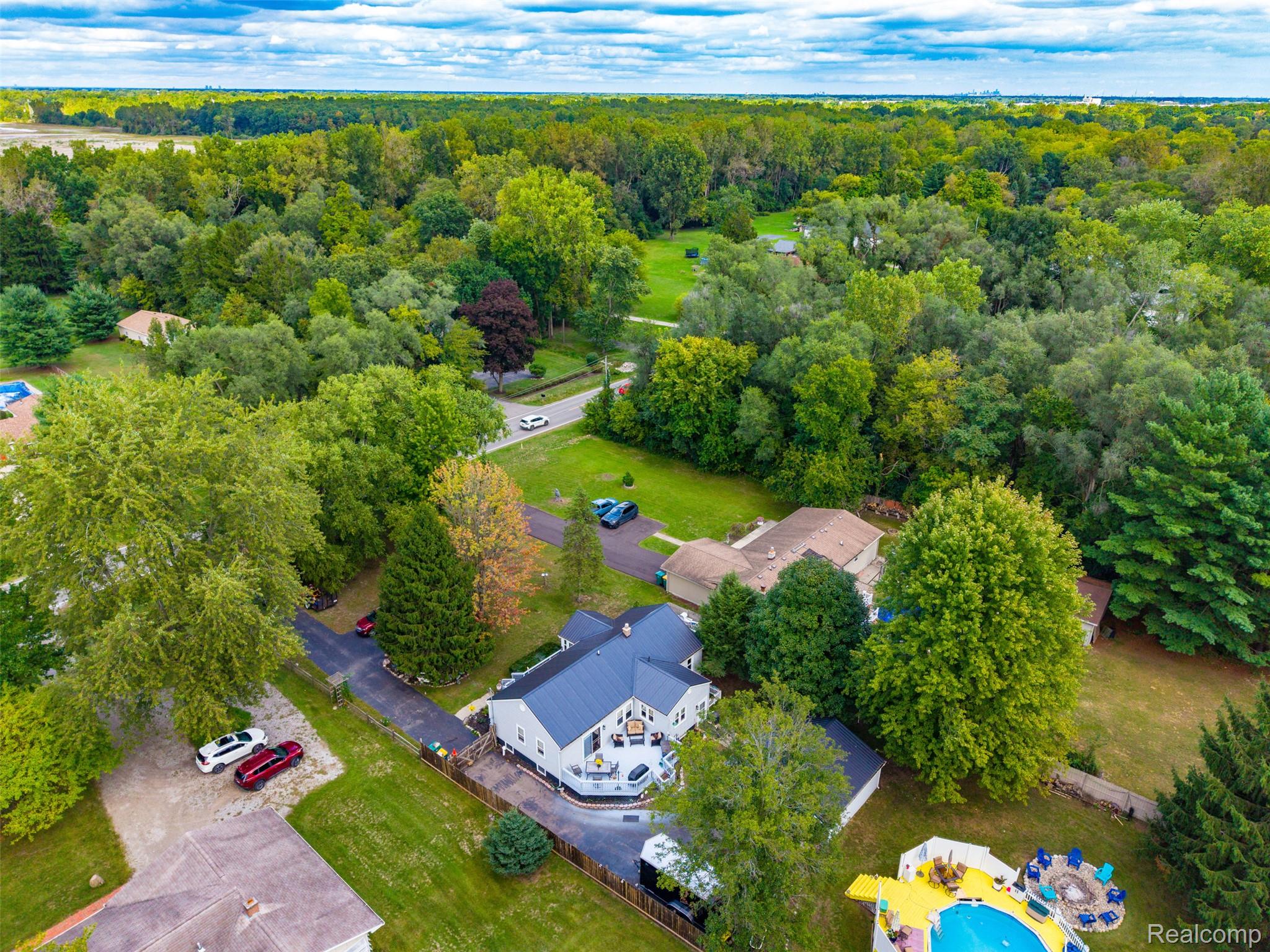 36739 Wick Road Romulus, MI 48174 - Photo 47 of 56 Aerial perspective showcasing a light-colored exterior, dark roof, and a circular driveway