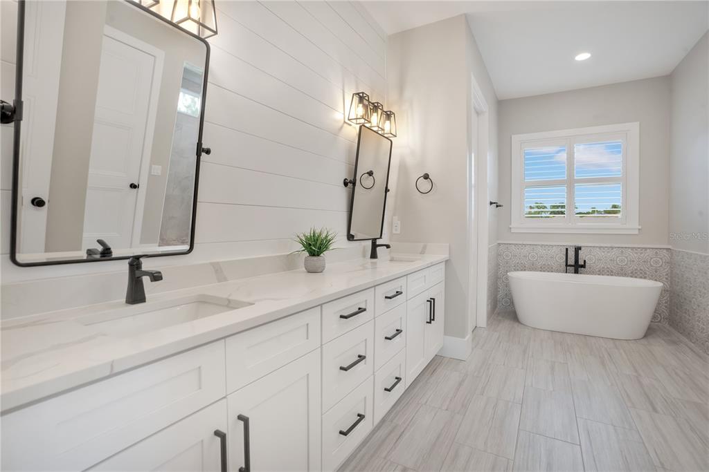 440 Palma Ceia Road Winter Haven, FL 33884 - Photo 30 of 78 a bathroom with a granite countertop sink and a large mirror