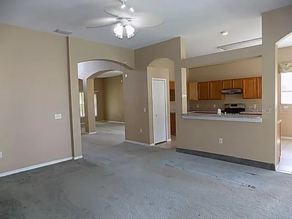 a view of a kitchen with a sink and dishwasher a refrigerator with wooden floor