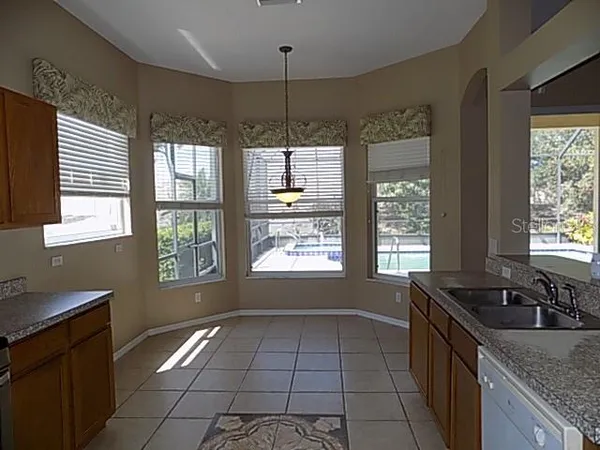 a kitchen with a sink stove and cabinets