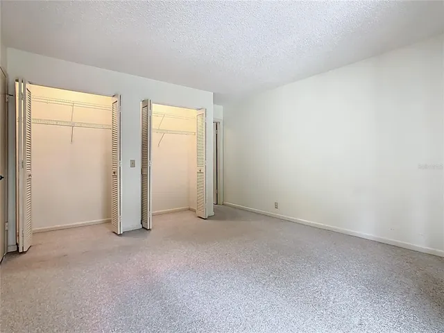 an empty room with closet area