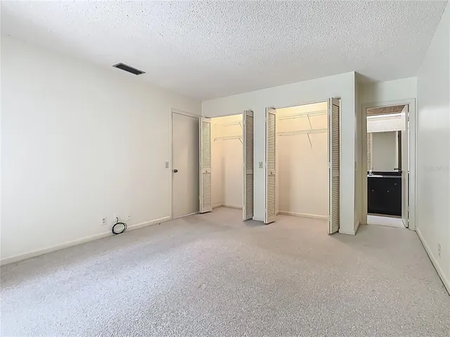 an empty room with closet area