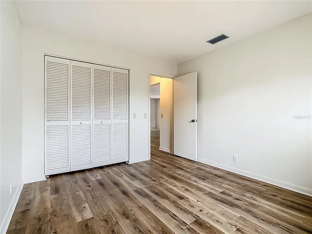 a white bath tub sitting next to a white sink and vanity