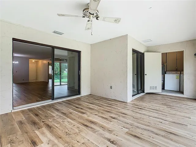 a view of an empty room with glass door