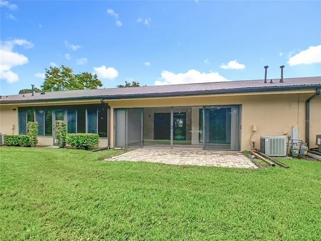 a view of a big yard with a large trees and plants