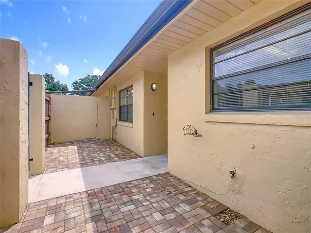 a front view of a house with a yard and potted plants