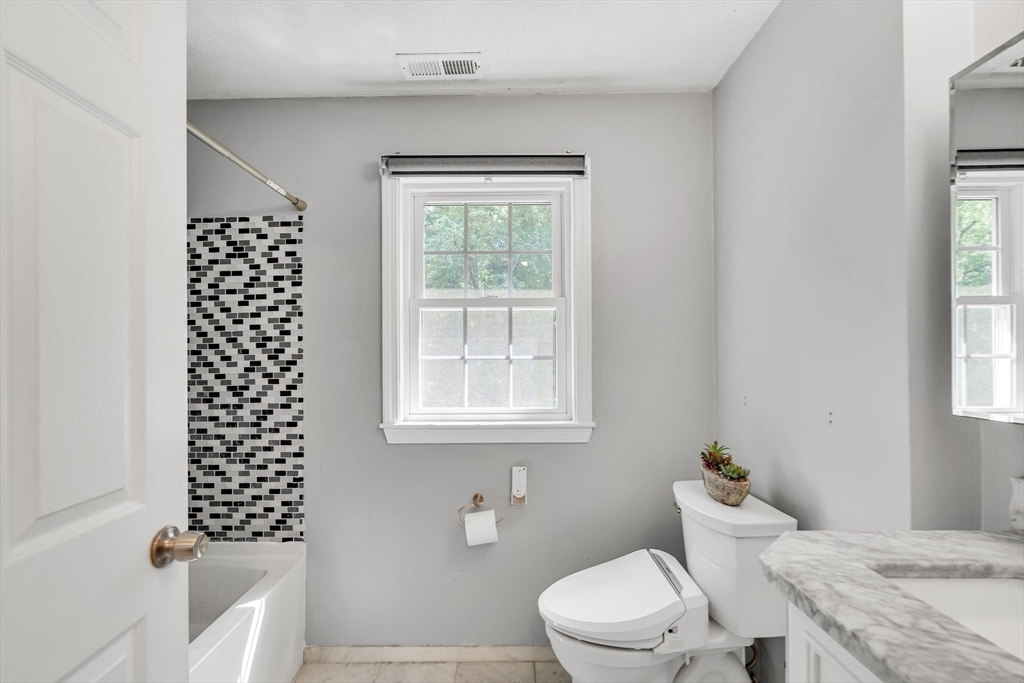 58 MacIntosh Lane, Unit 58 Boxborough, MA 01719 - Photo 13 of 23 a bathroom with a sink a toilet and a window
