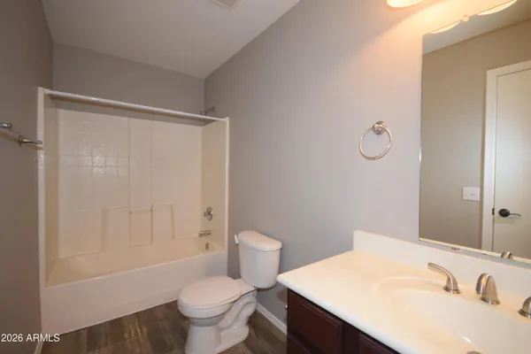 a bathroom with a sink toilet vanity and shower
