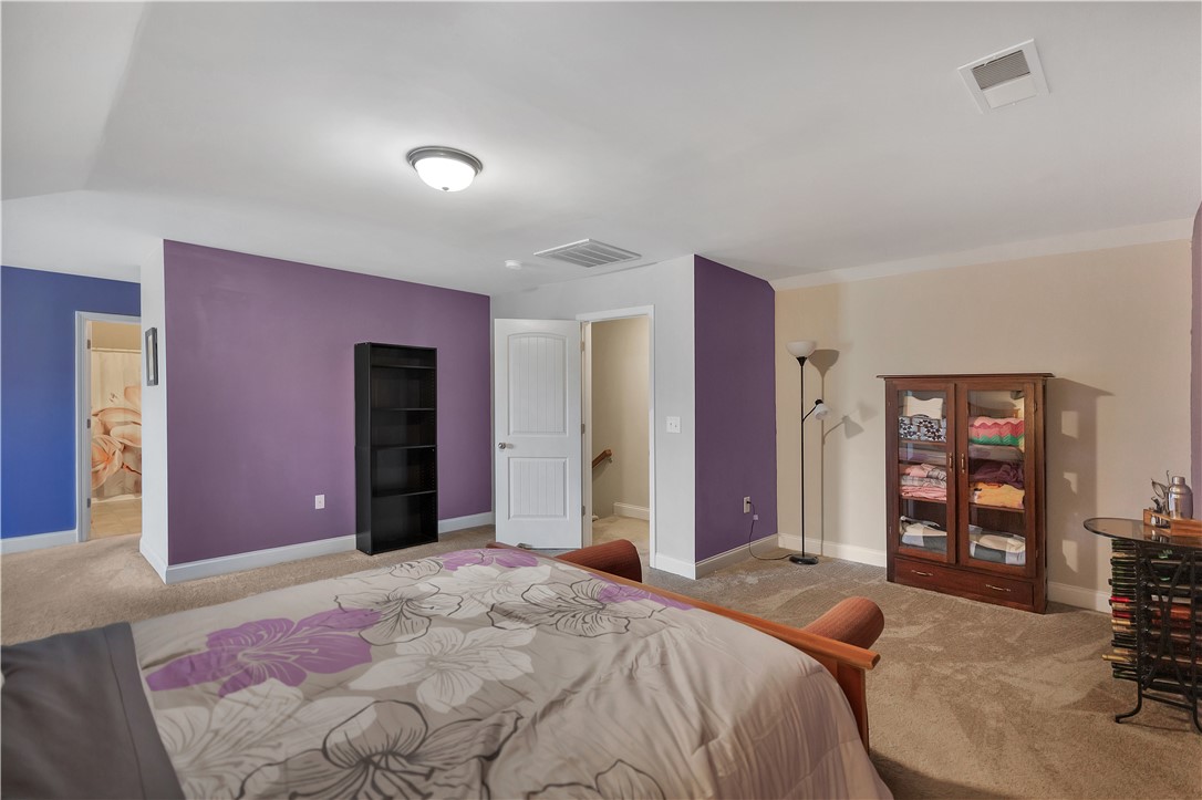 121 Ventura Street Anderson, SC 29621 - Photo 13 of 32 A well-lit bedroom features plush carpeting and a convenient doorway leading to additional living spaces.