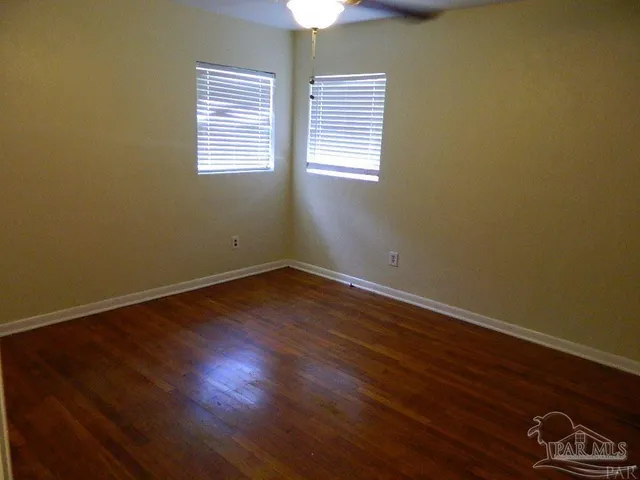 a room with a window and wooden floor