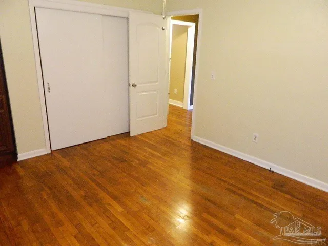 a view of closet with wooden floor