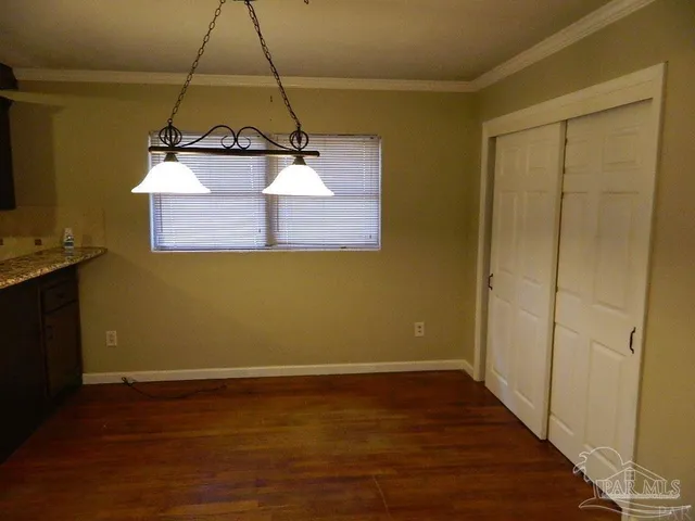 a view of a room with wooden floor