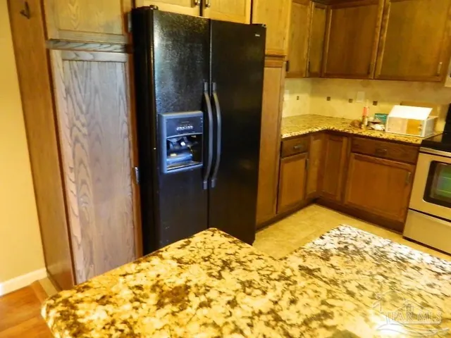 a kitchen with stainless steel appliances a refrigerator and a sink