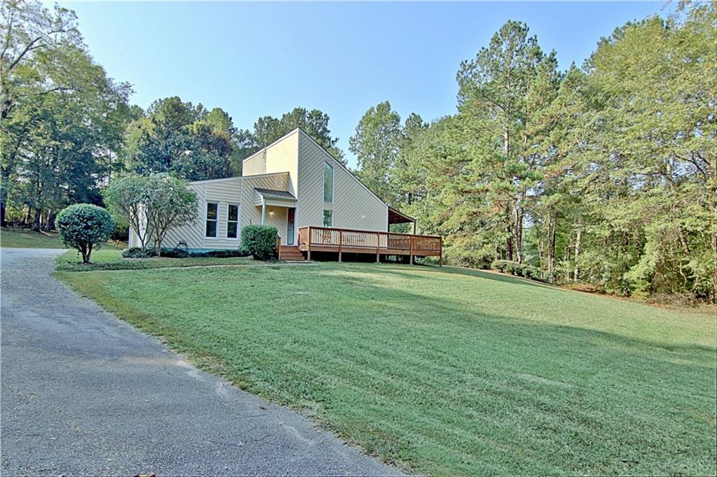 10700 Woodruff Road Fairburn, GA 30213 - Photo 1 of 1 a front view of a house with garden