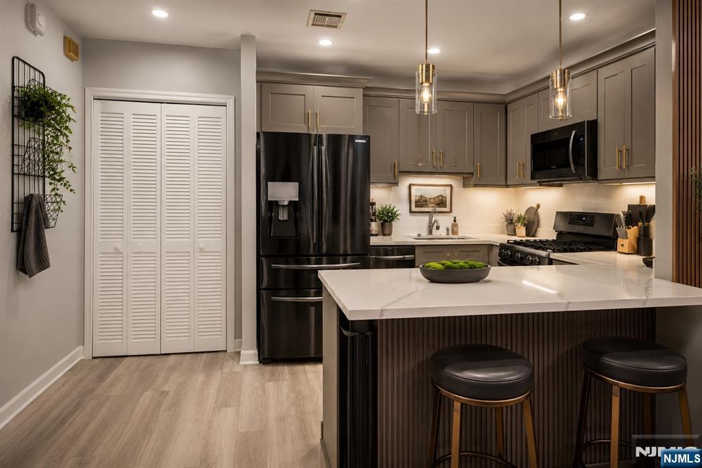 84 Union Street Newark, NJ 07105 - Photo 2 of 39 a kitchen with stainless steel appliances a refrigerator and a sink