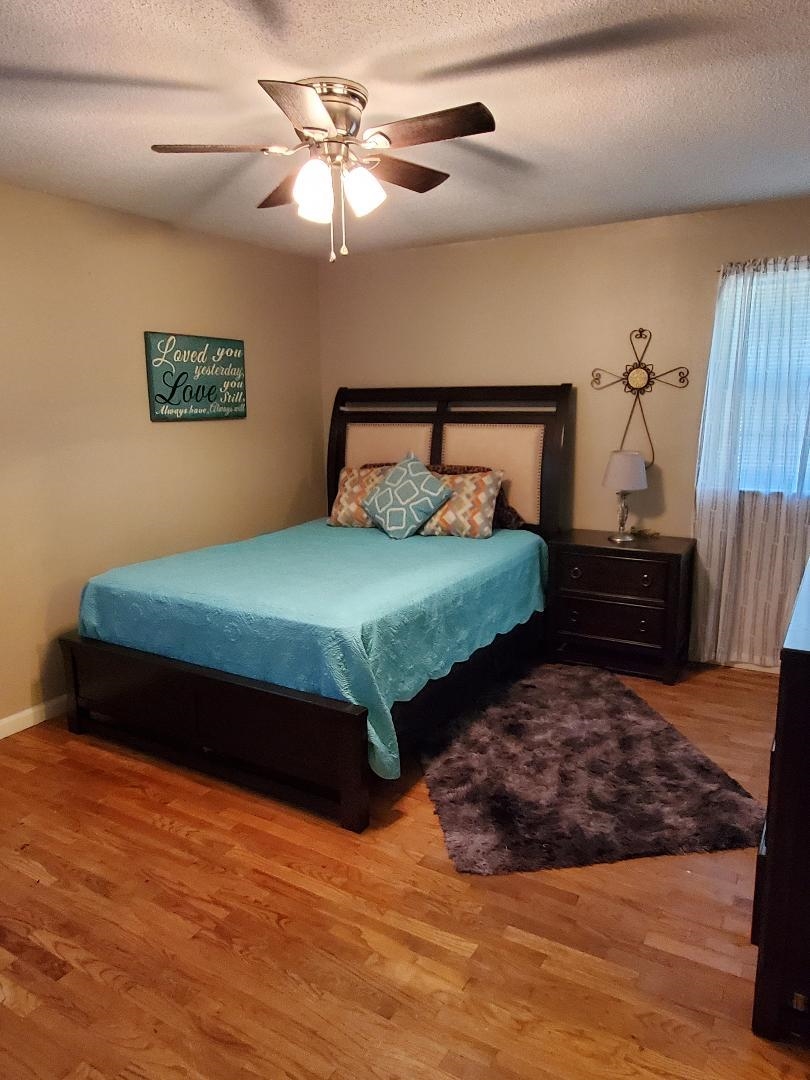 3232 Canisbay Road Memphis, TN 38128 - Photo 13 of 23 a bedroom with a bed and a chandelier