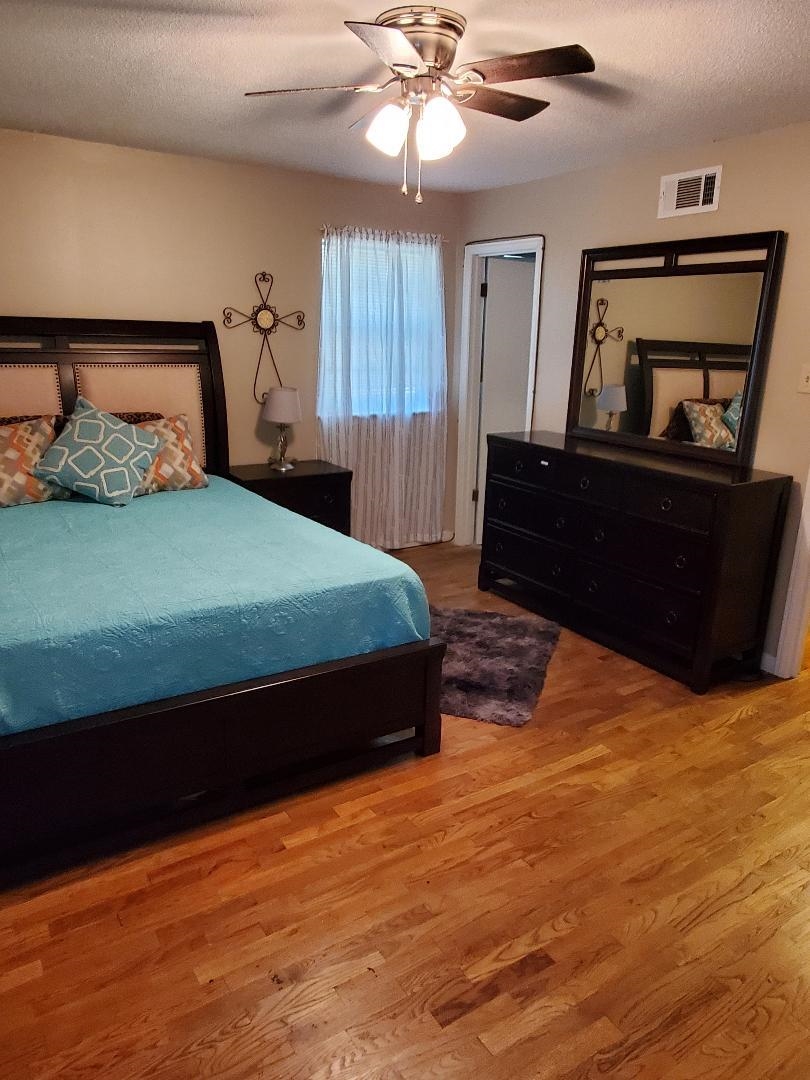 3232 Canisbay Road Memphis, TN 38128 - Photo 14 of 23 a bedroom with a bed and wooden floor