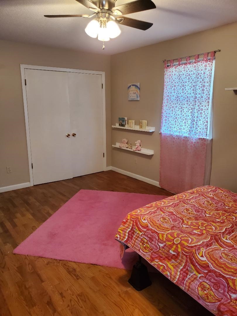 3232 Canisbay Road Memphis, TN 38128 - Photo 20 of 23 a bedroom with a bed and a chandelier