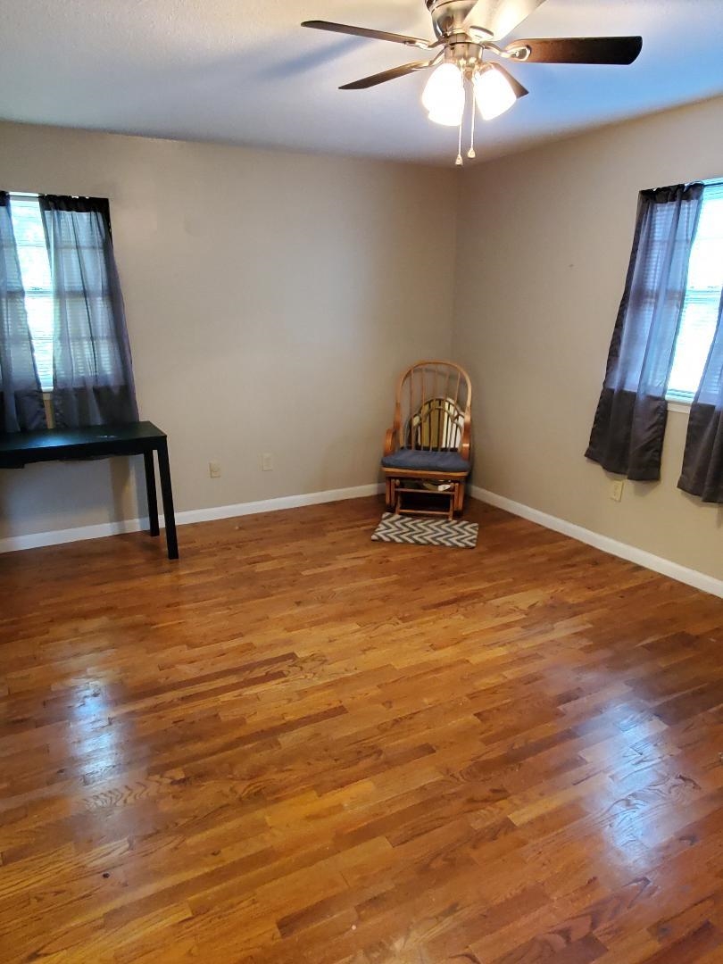 3232 Canisbay Road Memphis, TN 38128 - Photo 23 of 23 a view of an empty room with a window and wooden floor