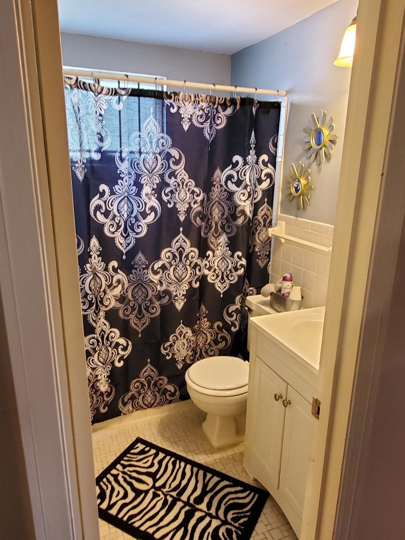 3232 Canisbay Road Memphis, TN 38128 - Photo 7 of 23 a bathroom with a toilet and a shower curtain