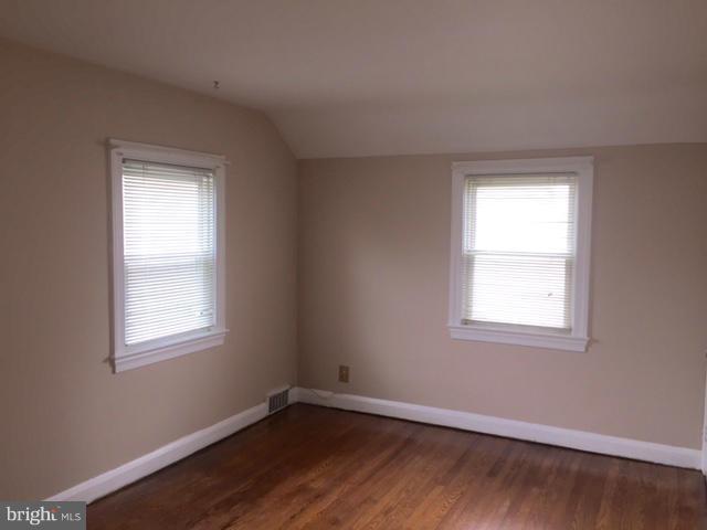 3014 Dunmurry Road Baltimore, MD 21222 - Photo 14 of 24 a view of an empty room with wooden floor and a window