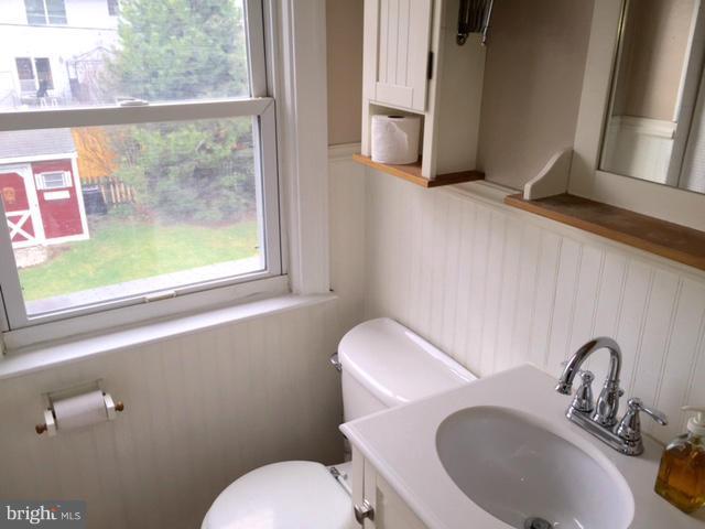 3014 Dunmurry Road Baltimore, MD 21222 - Photo 16 of 24 a bathroom with a toilet sink and mirror