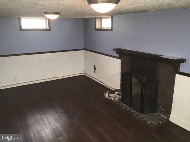 3014 Dunmurry Road Baltimore, MD 21222 - Photo 18 of 24 a view of an empty room with wooden floor and a window