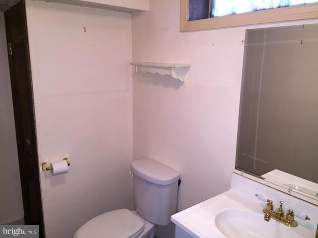 3014 Dunmurry Road Baltimore, MD 21222 - Photo 19 of 24 a white toilet sitting next to a bathroom sink