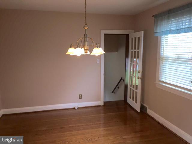 3014 Dunmurry Road Baltimore, MD 21222 - Photo 8 of 24 a view of an empty room with wooden floor and a window