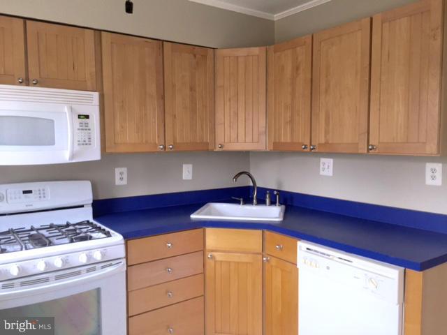 3014 Dunmurry Road Baltimore, MD 21222 - Photo 9 of 24 a kitchen with stainless steel appliances granite countertop wooden cabinets a sink and a stove