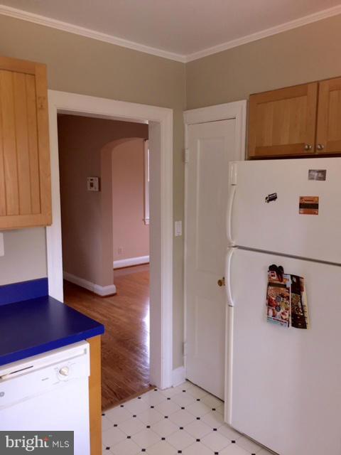 3014 Dunmurry Road Baltimore, MD 21222 - Photo 10 of 24 a hallway with cabinets and wooden floor